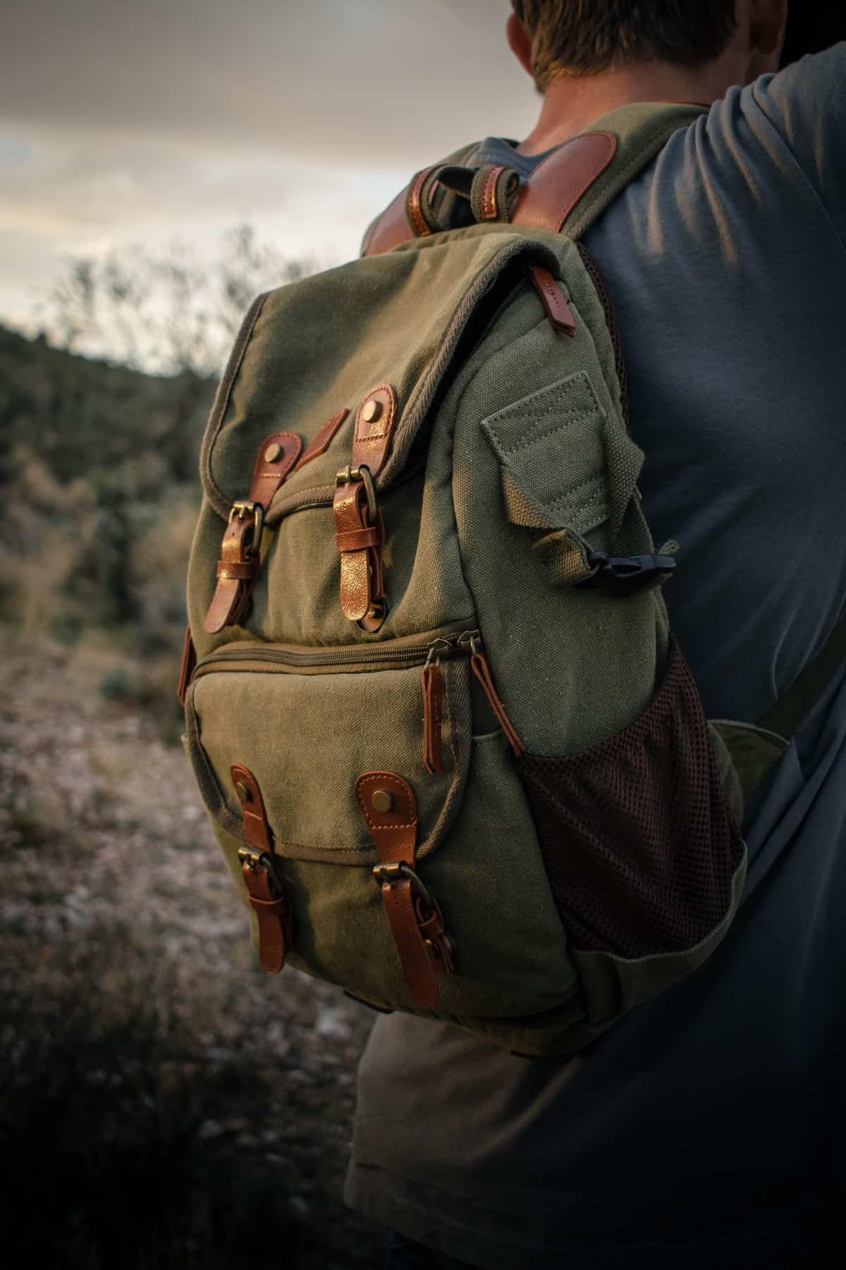 A man wearing a green backpack.