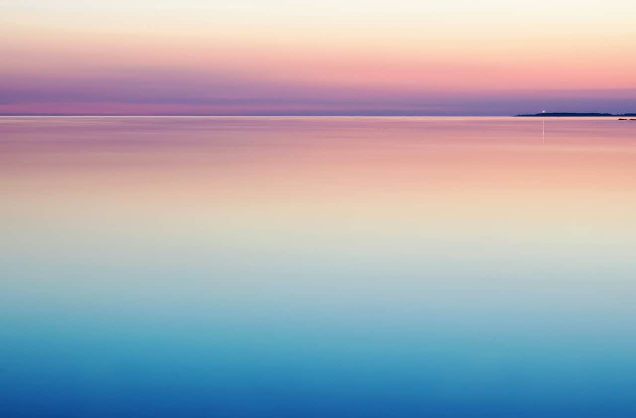 A purple and pink sunset over calm waters.