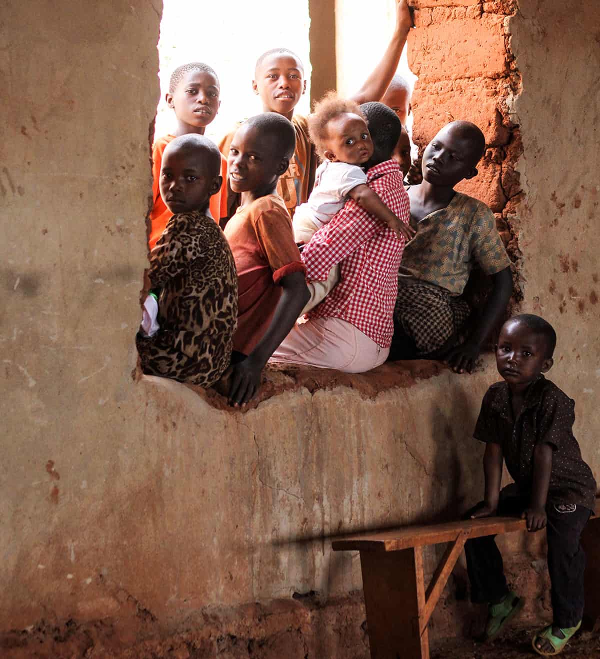 Rwanda children sitting in window.