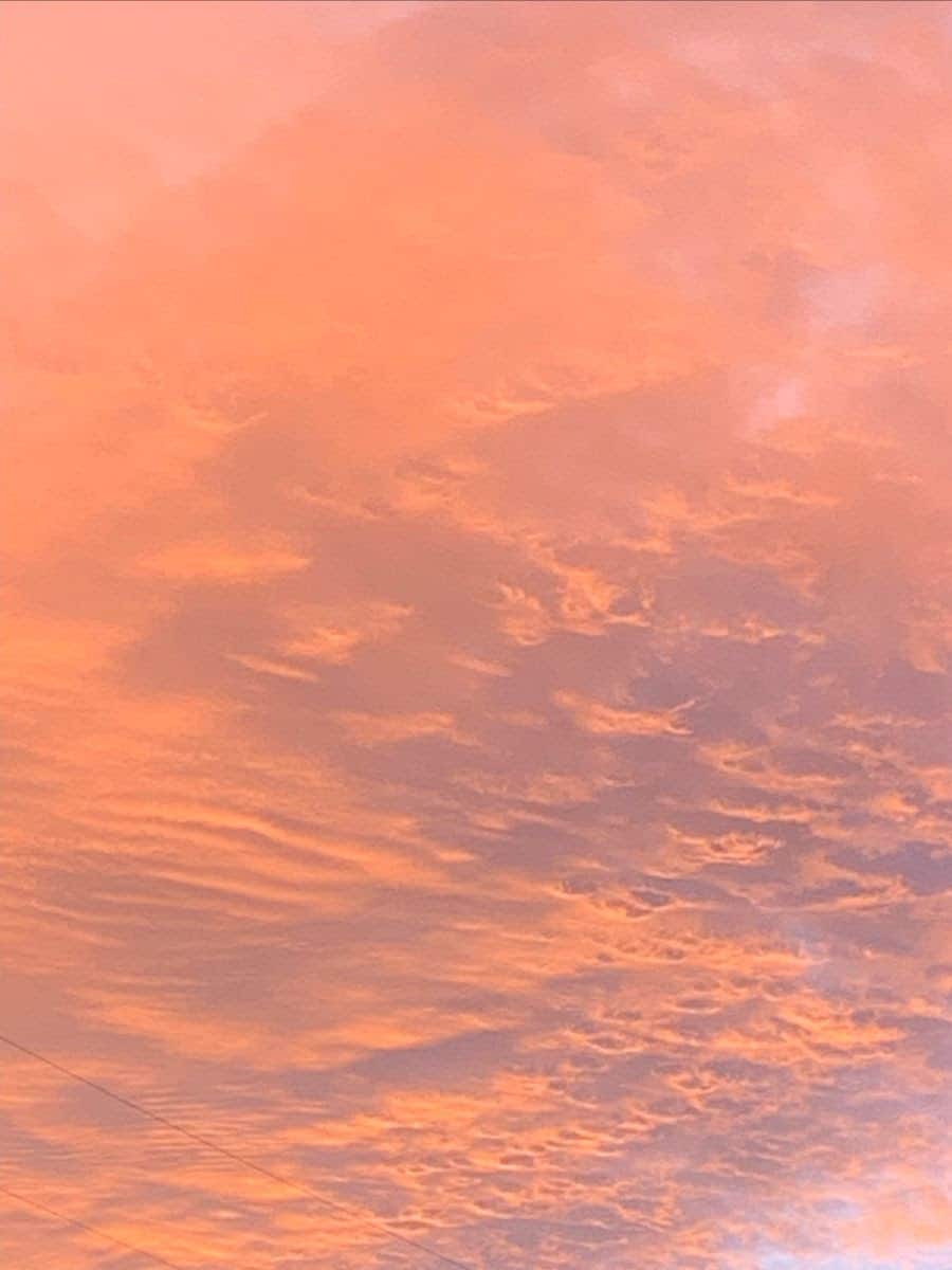 A sunset sky with orange, white, and blue colors.