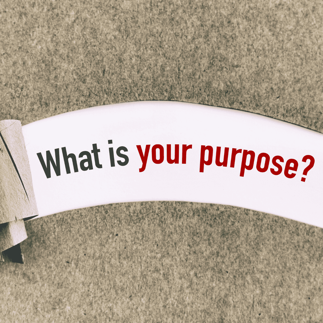 Tan paper peeled back revealing the question "What is your purpose?" underneath on white background.