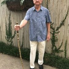 Bill dotson standing outside with his cane