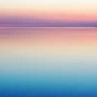 A purple and pink sunset over calm waters.