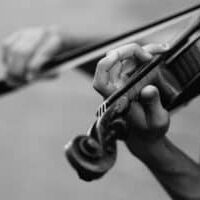 Black and white picture of a man's hands playing a fiddle