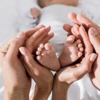 newborn-baby-feet-with-parents-hands